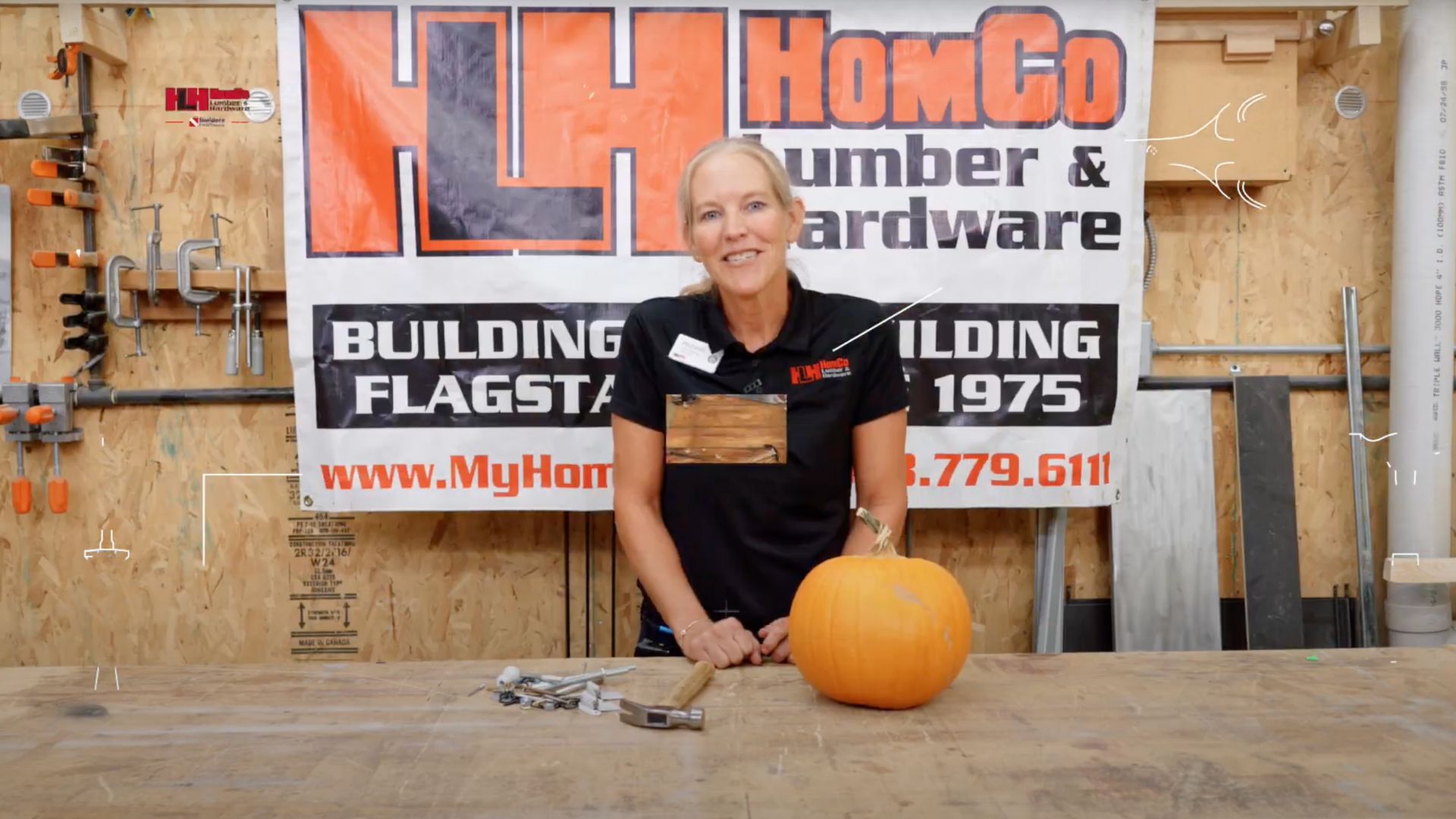 woman smiling with pumpkin and assorted hardware
